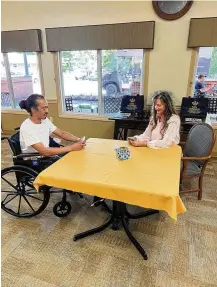  ?? ?? Danielle Feltner decided to build her career in the long-term care field after realizing how much she enjoyed caring for residents when she was a teenager working in a housekeepi­ng role. She is shown with New Lebanon Rehabilita­tion & Health Care Center resident Daryl Montgomery (left) playing cards.