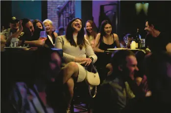  ?? NATACHA PISARENKO/AP PHOTOS ?? An audience enjoys Serhiy Lipko’s wedding-day comedy routine Saturday in Kyiv, Ukraine.