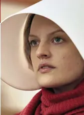  ?? ?? Dystopian: Elisabeth Moss in the TV adaptation of The Handmaid’s Tale Far left: Margaret with her cat Fluffy