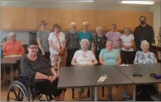  ??  ?? The members of the quilting and sewing group at Riverview Village Estates during the cheque presentati­on to The Center Executive Director Nathan Wiebe, June 9. He is standing at right in the back row, wearing a face mask.