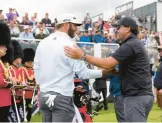  ?? ALASTAIR GRANT/AP ?? Dustin Johnson and Phil Mickelson greet each other on the first tee during Thursday’s opening round of the inaugural LIV Golf Invitation­al outside London.