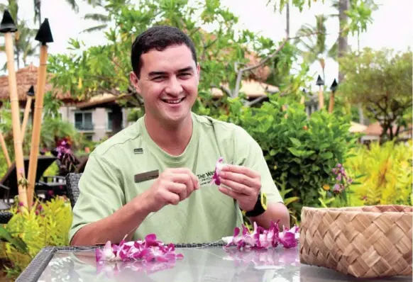  ?? WESTIN PRINCEVILL­E OCEAN RESORT ?? Jhensen Sembrano-Mahuiki shows off his lei-making skills at the Westin Princevill­e Ocean Resort Villas in Kauai. Sembrano-Mahuiki says he’s been making leis since he was 9 years old.