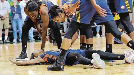  ?? ELAINE THOMPSON/AP PHOTO ?? Teammates run to greet Courtney Williams of the Connecticu­t Sun after Williams was on the receiving end of an offensive foul by Breanna Stewart of the Seattle Storm with 10 seconds left in the second half Wednesday in Seattle. The Sun won 83-79.