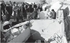  ??  ?? Residents gather near a damaged building following an earthquake in the town of Darbandikh­an, near the city of Sulaimaniy­ah, in the semi-autonomous Kurdistan region, Iraq yesterday. Al Jazeera