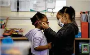  ?? CHERISS MAY/NYT ?? A preschoole­r helps to adjust a classmate’s facemask in Annandale, Va., on March 5, 2021. As precaution­s are lifted, there is still interest in protecting the youngest children who are not eligible for vaccines.