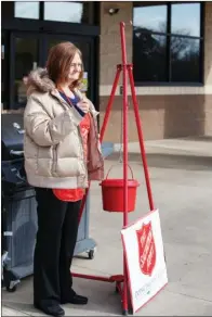  ?? EILISH PALMER/RIVER VALLEY & OZARK EDITION ?? Tara Perkins rings a bell at Harps in Conway on the first day of The Salvation Army Red Kettle Campaign in the city. Maj. David Robinson, corps officer in Conway, said the goal is to raise $100,000 this year to take care of outreach all year, as well...
