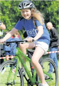  ??  ?? Tri-fest Another female student enjoys the cycle at the Landemer event