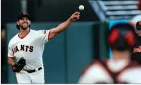  ?? RAY CHAVEZ — BAY AREA NEWS GROUP ?? Starting pitcher Madison Bumgarner warms up with catcher Buster Posey before their game against the Rockies at Oracle Park in San Francisco on Sept. 24.