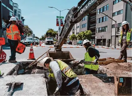  ?? Michaela Vatcheva/Special to the Chronicle 2023 ?? PG&E employees work at 14th and Guerrero streets in San Francisco on a hot April day. Employers could mitigate heat exposure by offering wearables and other technology that could instantane­ously assess risk to employees.