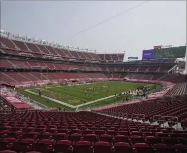  ?? JEFF CHIU ?? In this Sept. 13, 2020, file photo, empty seats are shown at Levi’s Stadium during the first half of an NFL football game between the San Francisco 49ers and the Arizona Cardinals in Santa Clara, Calif. The eight teams hosting NFL playoff games this month are more than happy to be staying home with all of comfort it brings, but the actual advantage of playing there all but disappeare­d during this pandemic season of mostly empty stadiums.