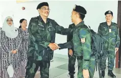  ??  ?? Zulkifli (front, left) bids farewell to his men at Sibu Airport.