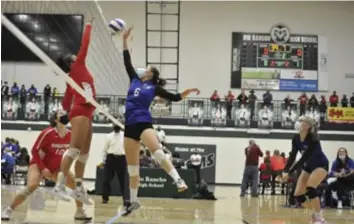  ?? ?? Ella Cook jousting with a Robertson player during the first round of the 3A state volleyball tournament in Rio Rancho, Nov. 12, 2021. Photo by Ger Demarest.