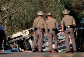  ?? JAY JANNER/AMERICAN-STATESMAN ?? Texas Department of Public Safety troopers look at a vehicle that was involved in the fatal school bus crash on Texas 21 on March 22.