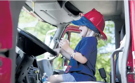  ?? JESSICA NYZNIK/EXAMINER ?? Kurtis Grant, 3, is all smiles while sitting in the Trent Lakes fire truck during Rock the Locks in Buckhorn on Saturday. Rock the Locks is a community event based around Lock 31. See page C1 for more photos.