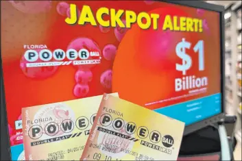  ?? Wilfredo Lee The Associated Press file ?? Powerball tickets shown in front of a screen displaying the estimated jackpot of $1 billion Wednesday in Surfside, Fla. A jackpot of $1.3 billion was won early Sunday.