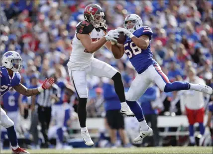  ?? ADRIAN KRAUS, THE ASSOCIATED PRESS ?? Buffalo Bills outside linebacker Matt Milano, right, intercepts a pass to Tampa Bay Buccaneers’ Cameron Brate in the first half Sunday in Orchard Park, N.Y. The Bills won the contest, 30-27, on a 30-yard field goal by Stephen Hauschka with 14 second...
