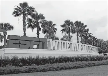  ?? JOHN RAOUX/AP PHOTO ?? A sign marking the entrance to ESPN’s Wide World of Sports at Walt Disney World is seen on Wednesday in Kissimmee, Fla. The NBA has told the National Basketball Players Associatio­n that it will present a 22-team plan for restarting the season at Disney.