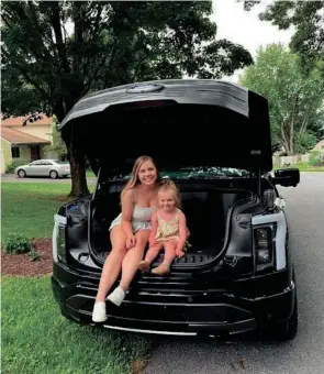  ?? PROVIDED BY JOE ROCCO ?? Ashley Rocco of Silver Spring, Maryland, is seated in the front trunk of a 2022 Ford F-150 Lightning with her niece Ollie. This image was taken June 10 in Frederick during a Hide-and-seek break.