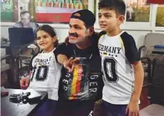  ?? Ahmed Kutty/Gulf News ?? Children watch the World Cup match between Germany and Mexico with their father at a cafe in Abu Dhabi. Parents have realised that forcing children to skip matches is not a great idea.