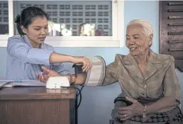  ?? AFP ?? A woman having her blood pressure checked at the elderly day care centre in Bangkok.