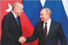  ?? AP ?? Russian President Vladimir Putin and Turkish President Recep Tayyip Erdogan shake hands during a news conference after their talks in Moscow yesterday.