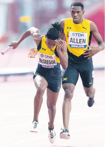  ?? GLADSTONE TAYLOR/MULTIMEDIA PHOTO EDITOR ?? Jamaica’s Nathon Allen (right) hands off the baton to Roneisha McGregor in the transition between first and second legs in the Mixed 4x400m relay final at the IAAF World Championsh­ips in Doha, Qatar on Sunday, September 29. The team, completed by Tiffany James and Javon Francis, claimed a silver medal.