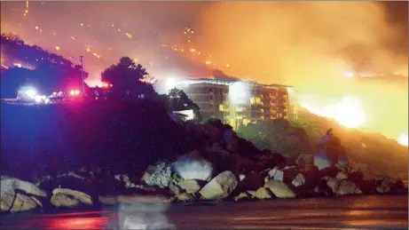  ?? Picture: JEFFREY ABRAHAMS ?? INFERNO: Residents were evacuated from No 1 Chapman’s Peak Drive in Hout Bay when the runaway fire threatened to engulf the building. Firefighte­rs saved the building from the flames.