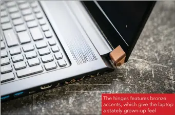  ??  ?? The hinges features bronze accents, which give the laptop a stately grown-up feel