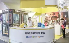  ??  ?? Visitors are seen at a booth of Tencent Music Entertainm­ent at the Beijing Music and Life Show in Beijing, China. — Reuters