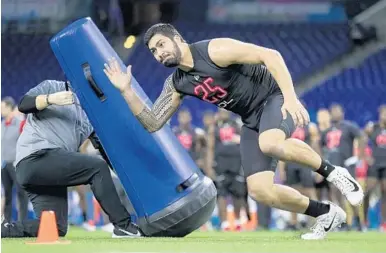  ?? MICHAEL CONROY/AP ?? Iowa defensive lineman A.J. Epenesa goes through a drill at the NFL scouting combine in Indianapol­is on Feb. 29.