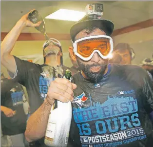  ??  ?? Toronto Blue Jays’ Jose Bautista (right) celebrates clinching the American League East Wednesday in Baltimore. The Jays have a magic number of three to clinch the top seed in the American League. They lead the Kansas City Royals by a game but own the...