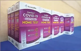  ?? Frederic J. Brown/afp via Getty Images/tns ?? Rapid COVID-19 test kits await distributi­on for free to people receiving their COVID-19 vaccines or boosters at Union Station in Los Angeles, California.