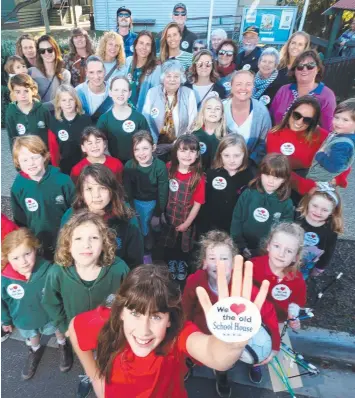  ??  ?? DON’T DO IT: Concerned parents and students outside Bellbrae Primary, where they are fighting the possible demolition of a century-old building. Picture: GLENN FERGUSON