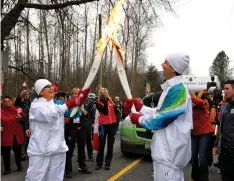  ?? AZIZ LADHA ?? Olympic torch bearer from the Ismaili community proudly carrying the flame in Vancouver.