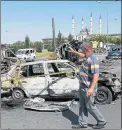  ??  ?? BURNT OUT: Police and civilian vehicles near the presidenti­al palace, in Ankara, which was attacked by a rebel airstrike.