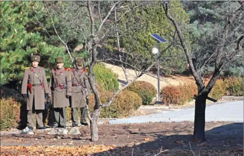  ?? AFP ?? North Korean soldiers stare at the South side at the truce village of Panmunjom in the Demilitari­sed Zone dividing the two Koreas on November 27.