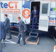  ?? Ken Dixon / Hearst Connecticu­t Media Group ?? Deputy Treasury Secretary Wally Adeyemo follows Gov Ned Lamont after a tour of a tenant-and-landlord assistance vehicle parked at the senior center in Middletown.