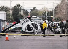  ?? LAS VEGAS REVIEW-JOURNAL FILE ?? Two pilots suffered minor injuries when a Metro police helicopter crashed on 23rd Street, near Bonanza Road, in December. A power loss contribute­d to the crash.