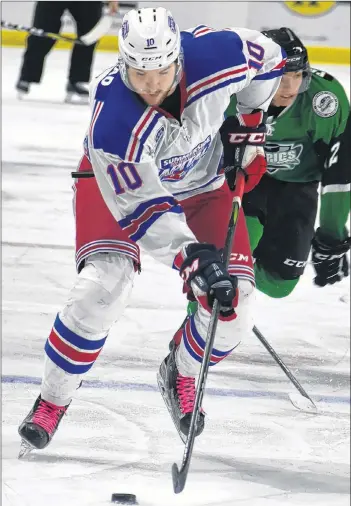  ?? DESIREE ANSTEY/JOURNAL PIONEER ?? Summerside Western Capitals forward Kallum Muirhead carries the puck up ice during Saturday’s Maritime Junior Hockey League game against the Grand Falls Rapids.