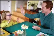  ?? ARIC CRABB — BAY AREA NEWS GROUP ?? Mark O'Neill plays a game with his daughter Emily, 4, in their home Wednesday in Oakland. O'Neill is a registered nurse at Stanford who lived in a hotel for 3 months during the early days of the pandemic because he was treating COVID patients.