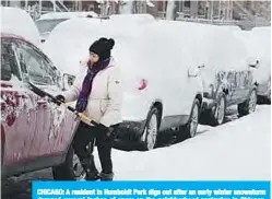  ?? —AFP ?? CHICAGO: A resident in Humboldt Park digs out after an early winter snowstorm dumped several inches of snow on the neighborho­od yesterday in Chicago, Illinois.