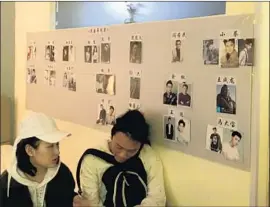  ??  ?? ZHONG and his client Yi Yao discuss roles in a hotel room-turned-casting office. A director has pinned photos of famous actors under the roles he is looking to fill.