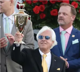  ?? Tribune News Service/getty Images ?? In this photo from May 1, trainer Bob Baffert of Medina Spirit, raises the trophy after winning the 147th running of the Kentucky Derby with Medina Spirit, his seventh career Kentucky Derby win, at Churchill Downs in Louisville, Kentucky.