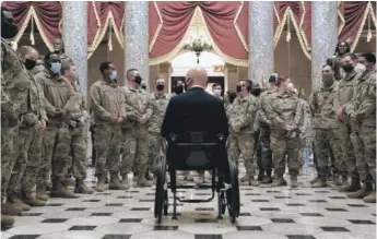  ?? STEFANI REYNOLDS/GETTY IMAGES ?? Rep. Brian Mast, R-Fla., gives members of the National Guard a tour of the U.S. Capitol on Wednesday.