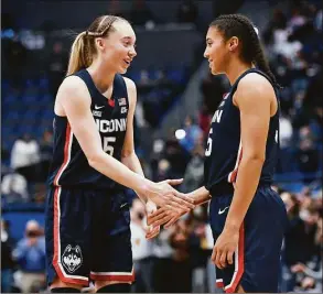  ?? Jessica Hill / Associated Press ?? UConn’s Paige Bueckers, left, shakes hands with teammate Azzi Fudd after a game against Arkansas on Nov. 14 in Hartford.