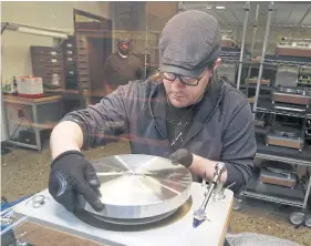  ??  ?? LEFT Worker Robert Powell assembles a turntable.