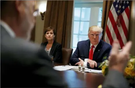  ?? EVAN VUCCI — THE ASSOCIATED PRESS ?? Iowa Gov. Kim Reynolds and President Donald Trump listen as Pennsylvan­ia Gov. Tom Wolf speaks during a meeting with governors on “workforce freedom and mobility” in the Cabinet Room of the White House, Thursday in Washington.