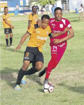  ?? (Photo :Norman Thomas) ?? Tivoli Gardens captain Wyan Nelson (left) and Bridgeport High’s Tremayne Anderson tussle for possession in their Group D match of the Issa/digicel Manning cup at Tivoli Gardens yesterday.