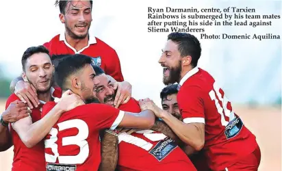  ??  ?? Ryan Darmanin, centre, of Tarxien Rainbows is submerged by his team mates after putting his side in the lead against Sliema Wanderers
Photo: Domenic Aquilina