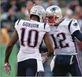  ?? The Boston Herald/tns ?? Josh Gordon of the New England Patriots is congratula­ted by Tom Brady after they connected for a 17 yard first down catch during the 4th quarter of the game at Metlife Stadium on Nov. 25 in East Rutherford, New Jersey.